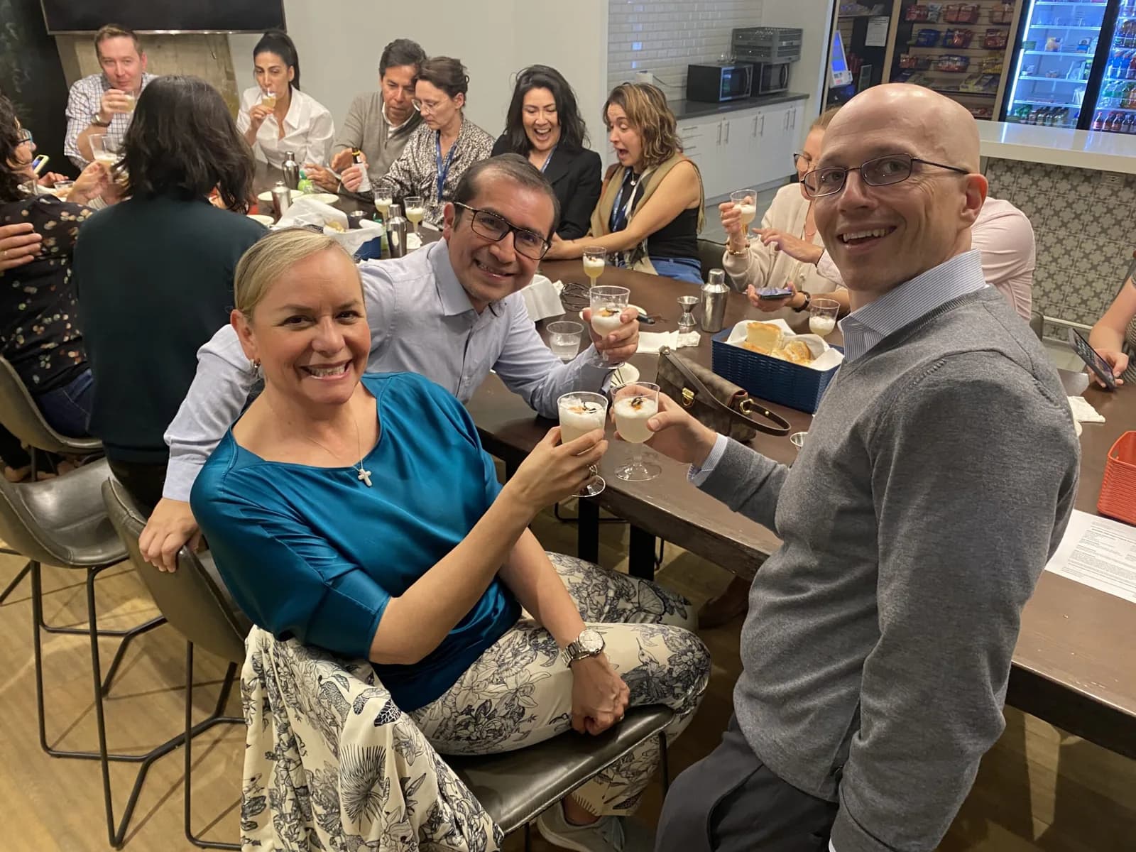 Corporate group toasting with handmade cocktails at a mixology class