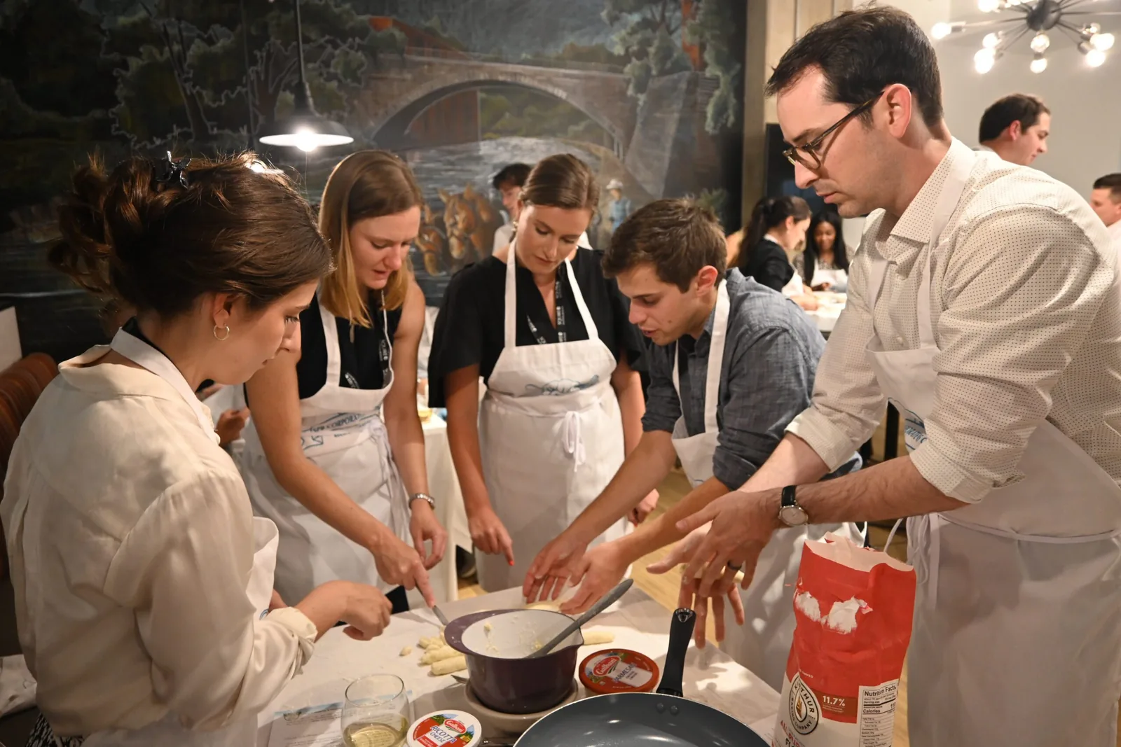 Group working hands-on around a table at a private cooking class