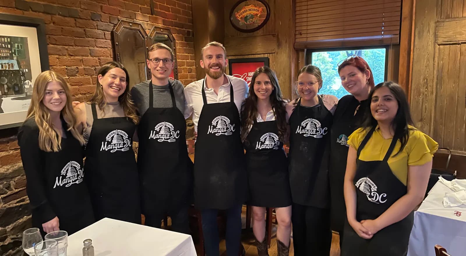 Group in Mangia DC aprons after a private cooking class